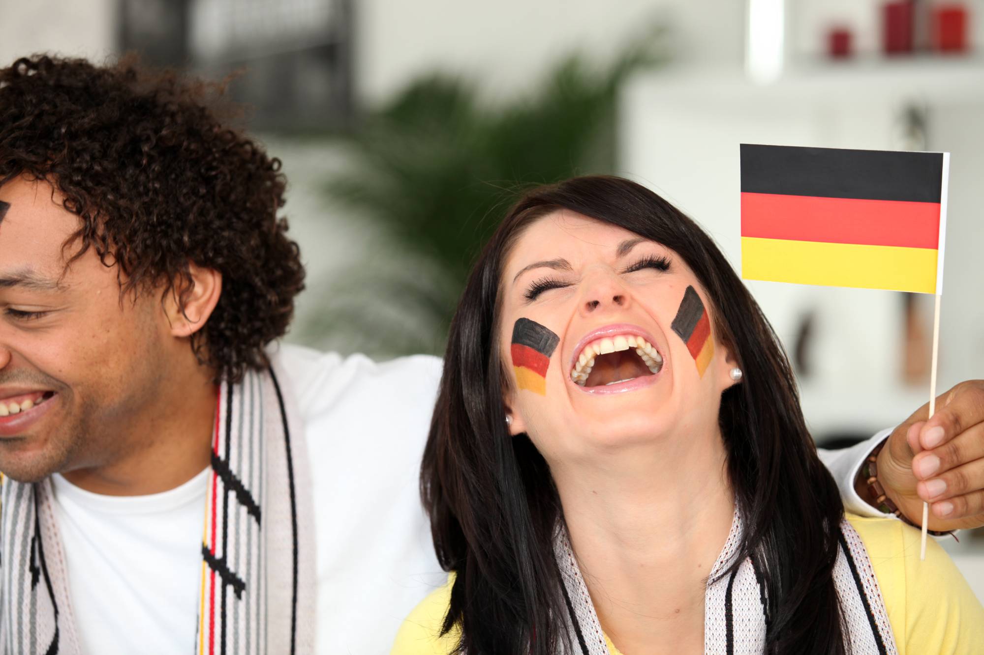 Couple holding a German flag and laughing