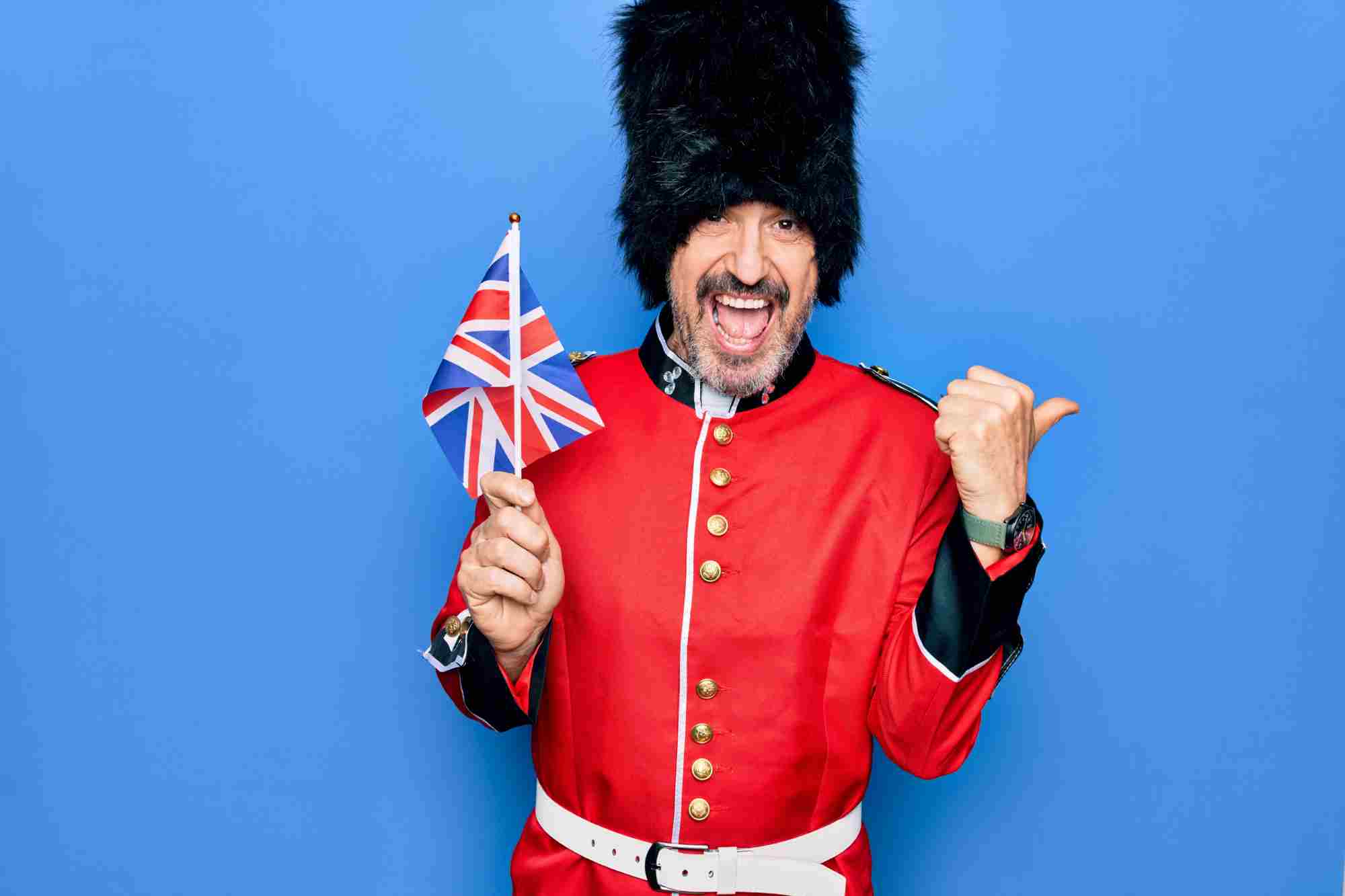 man dressed as a beefeater, laughing