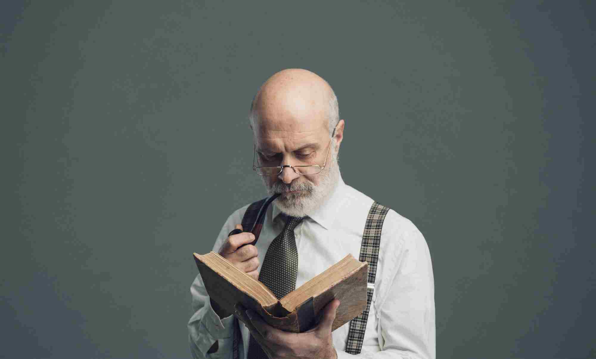 professor smoking a pipe and reading a book