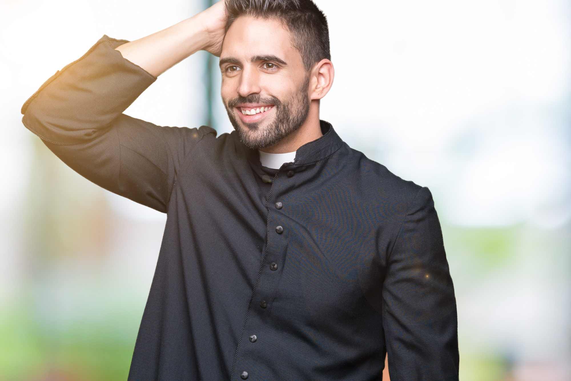 laughing and smiling Christian priest