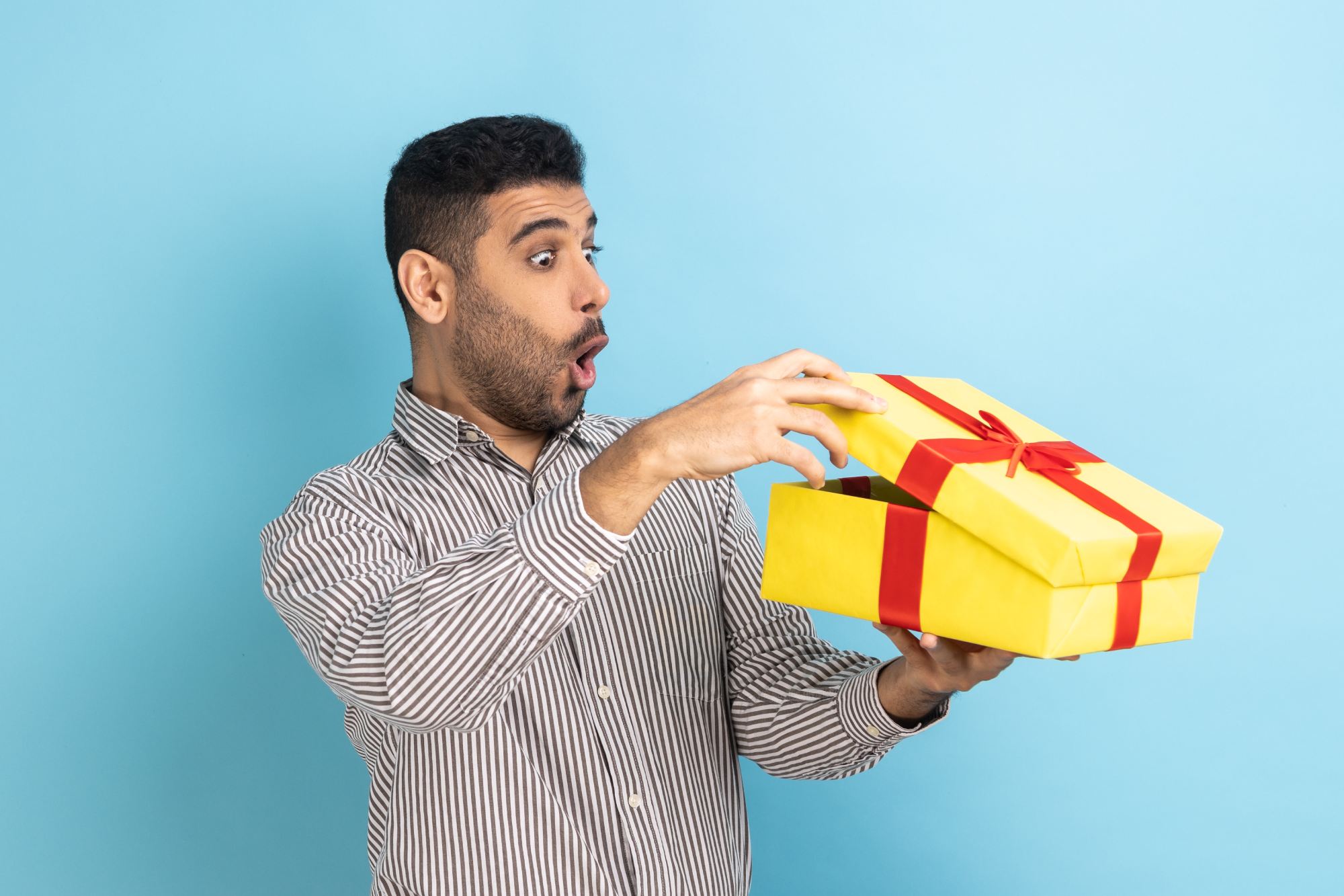 office worker looking inside a gift box and being amazed