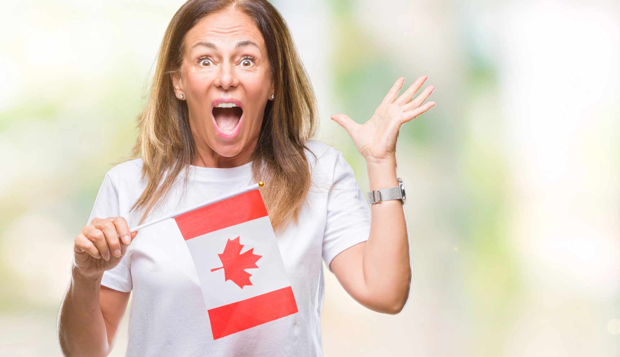 Canadian woman holding a flag and looking happy